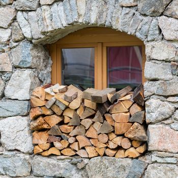 Firewood logpile stacked in a window - Austria