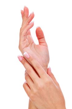 Closeup shot of woman's hands with french manicure and clean and soft skin over a white background, isolated