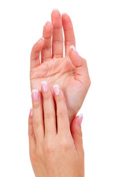 Closeup shot of woman's hands with french manicure and clean and soft skin over a white background, isolated