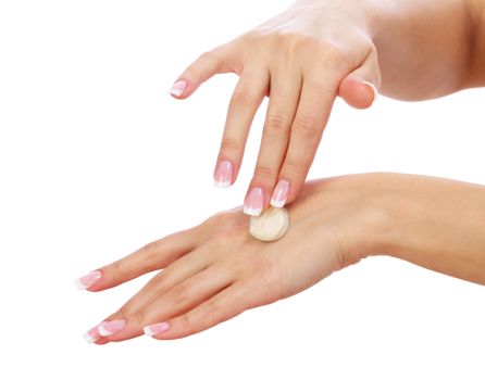 Closeup shot of woman applying moisturizing cream on hands, isolated on white background