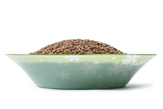 buckwheat grain in a green cup it is isolated on a white background