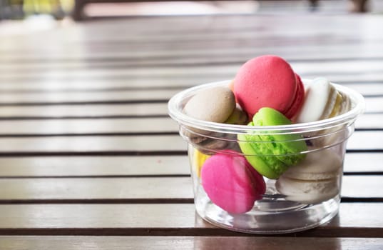 French macarons colorful on wood table, selective focus