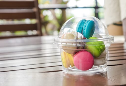 French macarons colorful on wood table, selective focus