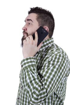 Young man with a beard speaks on a mobile phone