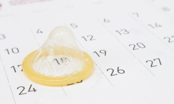 Closeup condom with calendar background for AIDs awareness concept