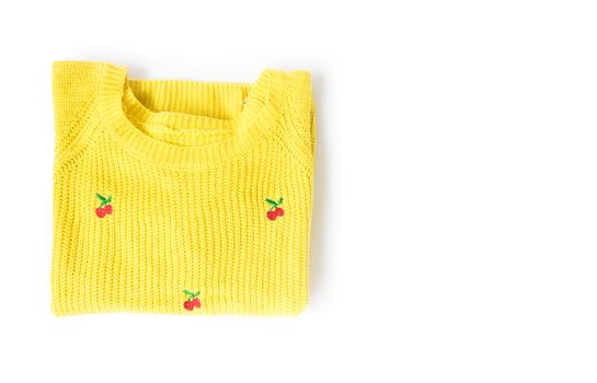 Top view yellow clothes knitting sweater on white background,workhouse concept