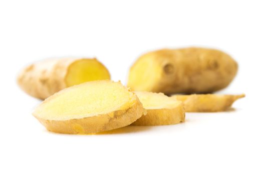 Fresh ginger on white background, raw material for cooking, selective focus