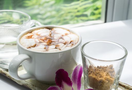 Closeup hot coffee on table with nature background, selective focus