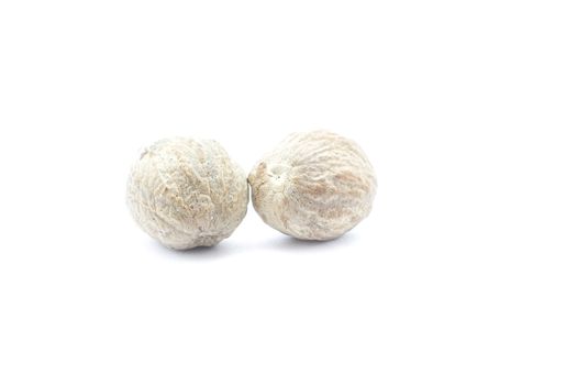 Nutmeg isolated on white background close-up.