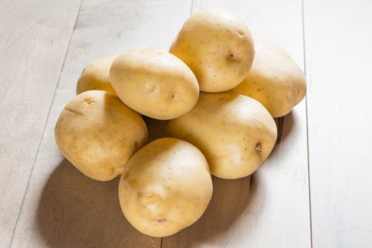 Yukon white potatoes photographed on a wooden table