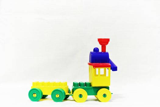 Child toy designer made of plastic train isolated on white background.