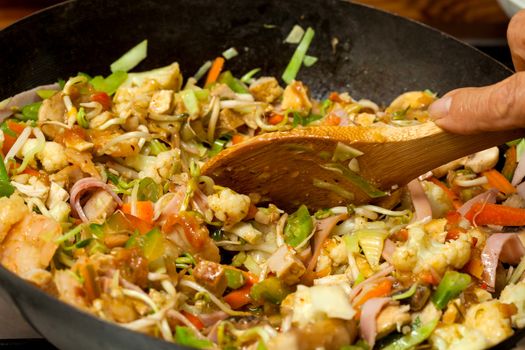 Sauteed vegetables with chicken, pork, jam and shrimps preparation : Cooking vegetables and meats into a wok