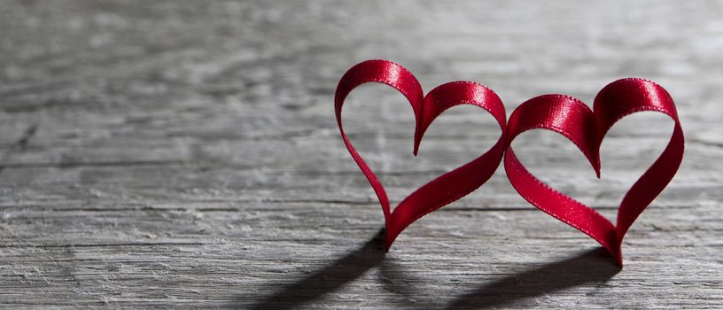 Two red ribbon hearts on wooden backround, Valentine day concept