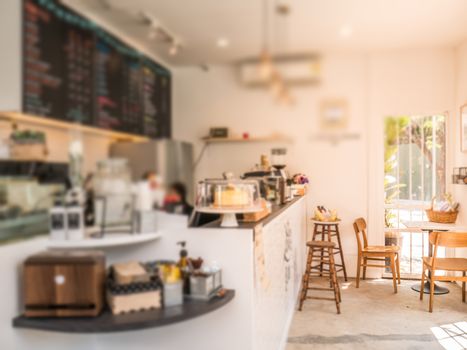 Blurred inside of coffee shop design in white warm tone