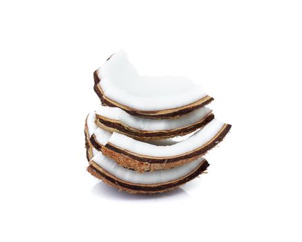 Pieces of coconut shell broken into pieces and stacked on white background