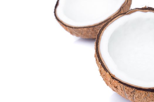 Closeup half of brown coconut shell on white background