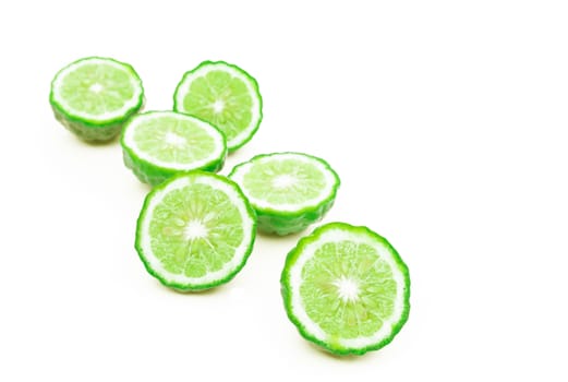 Closeup bergamot slice on white background, selective focus