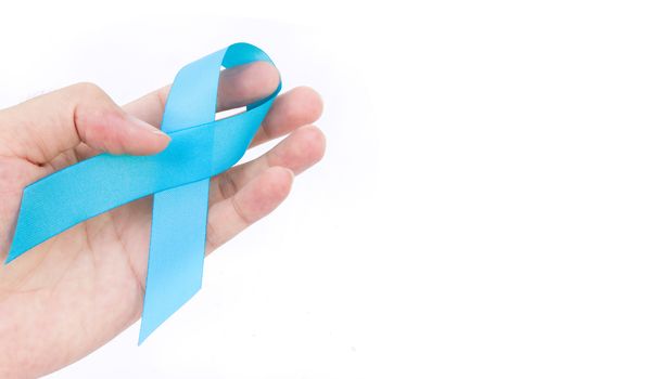 Hand hold blue ribbon on white background prostate cancer awareness concept