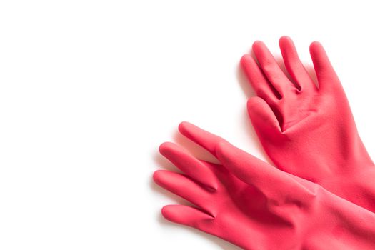 Closeup Red rubber gloves for cleaning on white background, workhouse concept