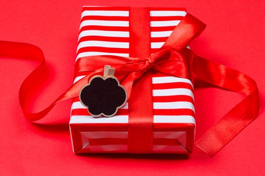 gift with red bow on red background. Free space for your text.