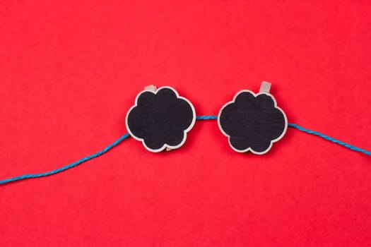 Clothespins with a place for writing on a red background