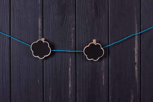 Clothespins with space for text on a black wooden fence