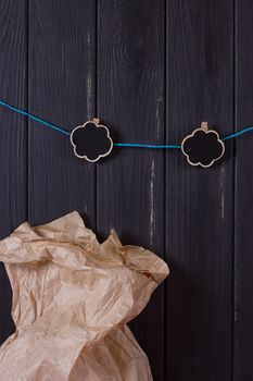 A craft bag near a black fence with a clothes peg and a place for text