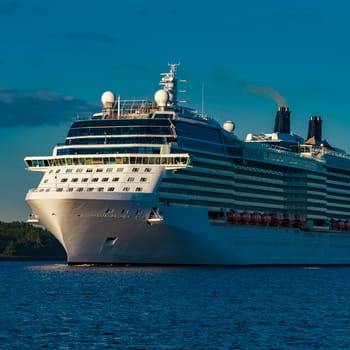 White giant brand new passenger ship moving in clear summer day