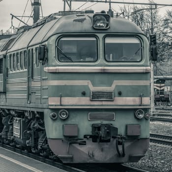 Old diesel cargo locomotive. Freight train in action