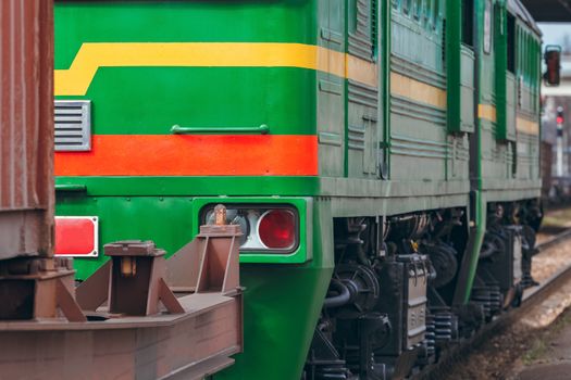 Green diesel cargo locomotive. Freight train in action