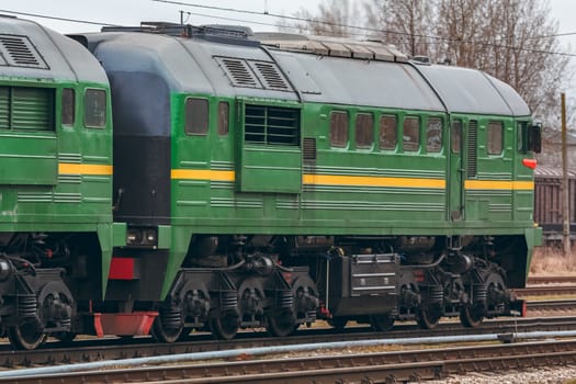 Green diesel cargo locomotive. Freight train in action