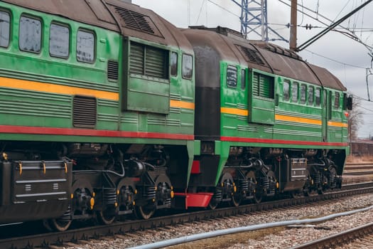Green diesel cargo locomotive. Freight train in action