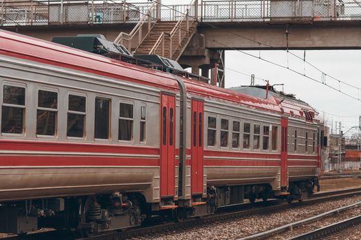 Red diesel passenger train driving at the old terminal