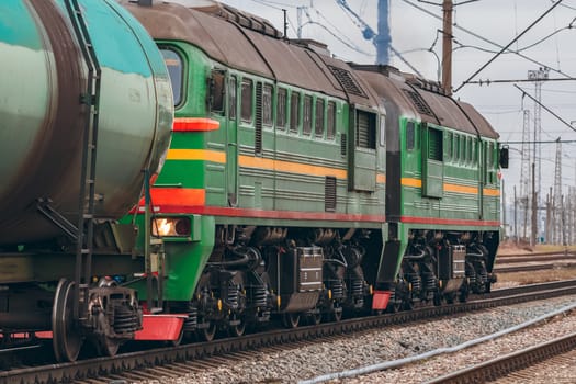 Green diesel cargo locomotive. Freight train in action