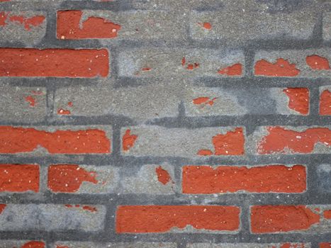 Red Worn Repaired Brickwall with Uneven Mortar Closeup