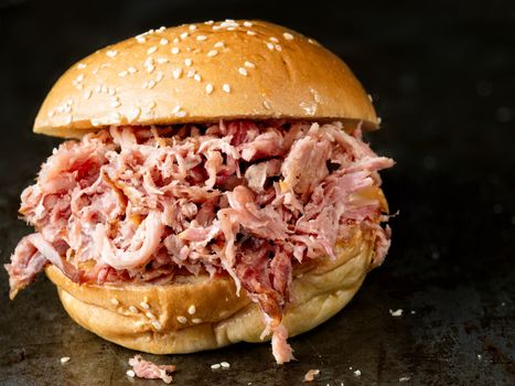 close up of rustic american barbecued pulled pork sandwich