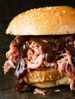 close up of rustic american barbecued pulled pork sandwich