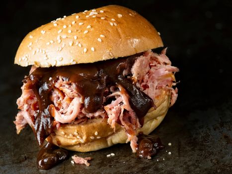 close up of rustic american barbecued pulled pork sandwich