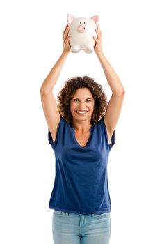 Portrait of a happy middle aged woman holding a Piggybank over her head