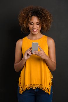 Beautiful African American woman texting a sms