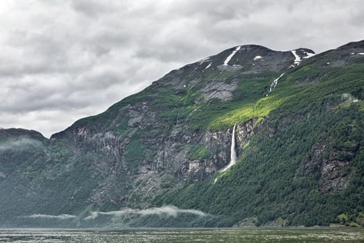 Mountains and waterfall in Geiranger in a cloudy day, Norway