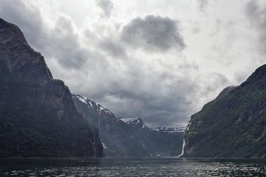 Sailing in the fjord near Geiranger in a cloudy day, Norway