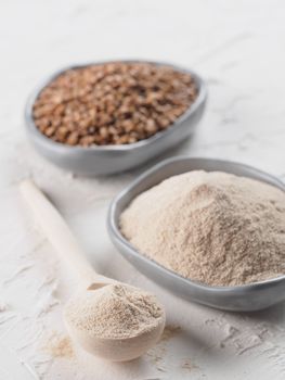 Buckwheat flour and buckwheat on white background