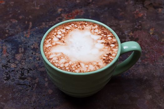 Hot chocolate with marshmallows on grunge dark table