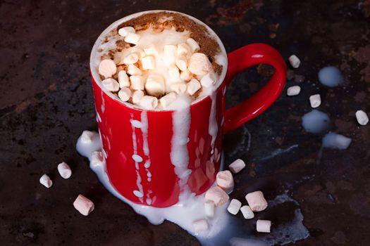 Hot chocolate with marshmallows on grunge dark table
