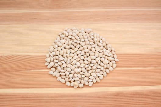 Neavy beans on a wooden background, pine wood grain
