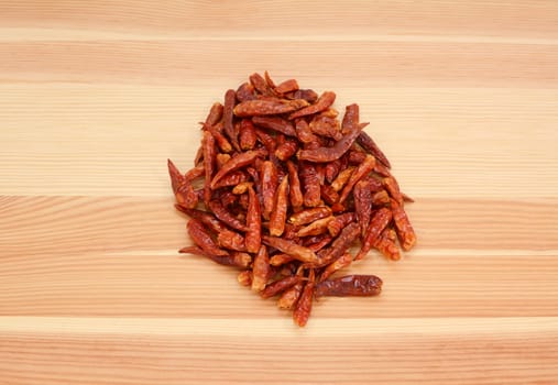 Birds eye chillis on a wooden background, pine wood grain