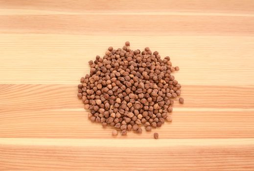 Black chickpeas on a wooden background, pine wood grain