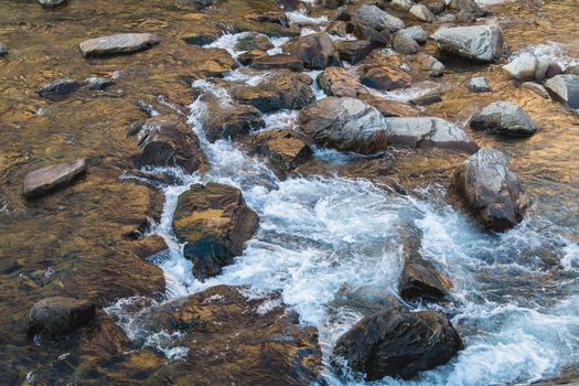 streaming water over the rocks in morning