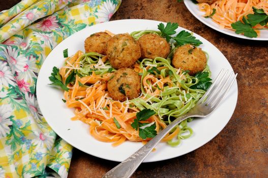 Spaghetti from carrots and spinach with chicken meatballs flavored cheese parmesan, herb